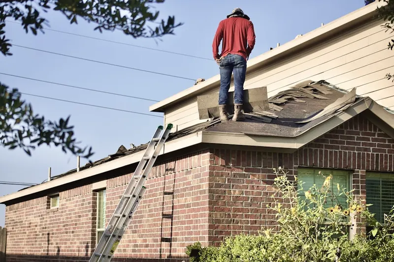 Professional roofer working on a residential roof in Waterton